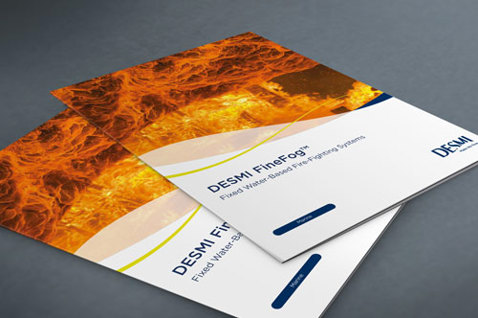 DESMI FineFog brochures for fixed water-based fire-fighting systems on a table.