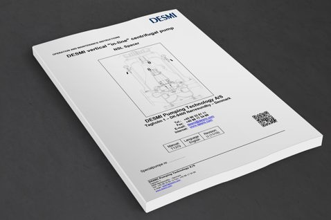 Manual for DESMI vertical in-line centrifugal pump, NSL Spacer, on a table.