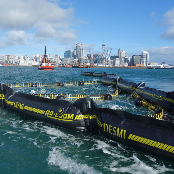 DESMI RO-BOOM in water with city skyline in the background.