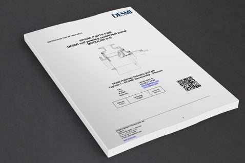 Instruction manual for DESMI self-priming centrifugal pump, Modular S-N, on a table.