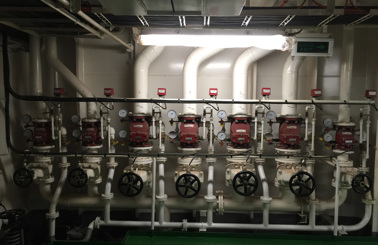 Industrial piping system with multiple valves and gauges for fluid handling.