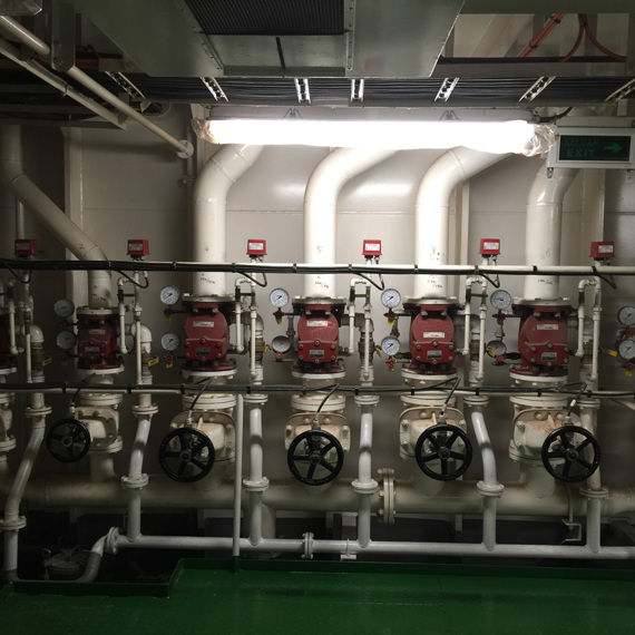 Industrial piping system with multiple valves and gauges for fluid handling.