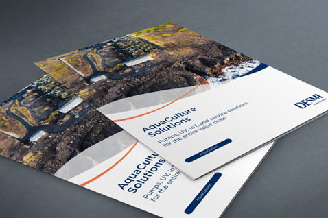 DESMI brochures titled "Aquaculture Solutions" on a gray surface.