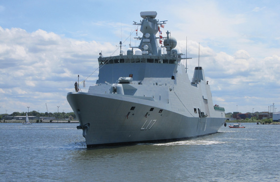 Large naval warship with L17 marking sailing on a calm, sunny day.