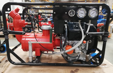 Red DESMI pump with gauges, hoses, and engine, used for fluid handling.