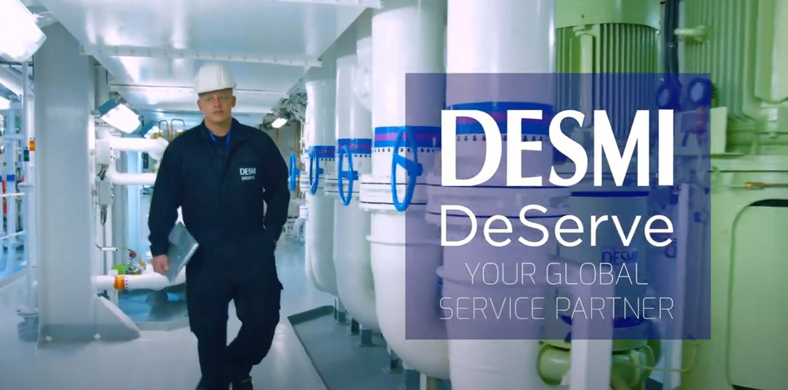 Worker in a DESMI uniform walking through an industrial facility for fluid handling.