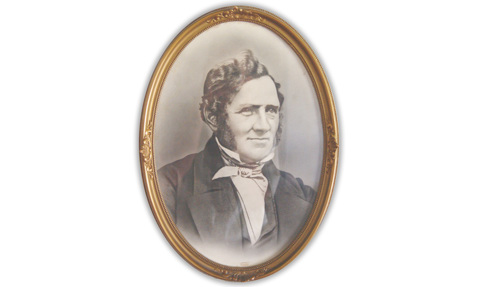 Oval-framed portrait of a man in 19th-century attire.