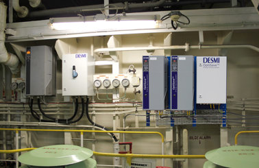 DESMI OptiSave energy-saving system with gauges and control panels for fluid handling.