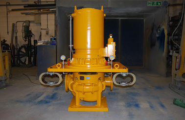 Yellow DESMI pump for fluid handling in an industrial workshop setting.