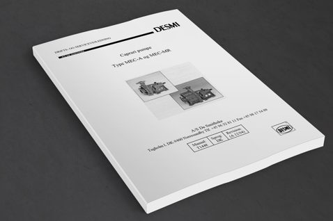 DESMI Caprari pump manual for MEC-A and MEC-MR models on a table.